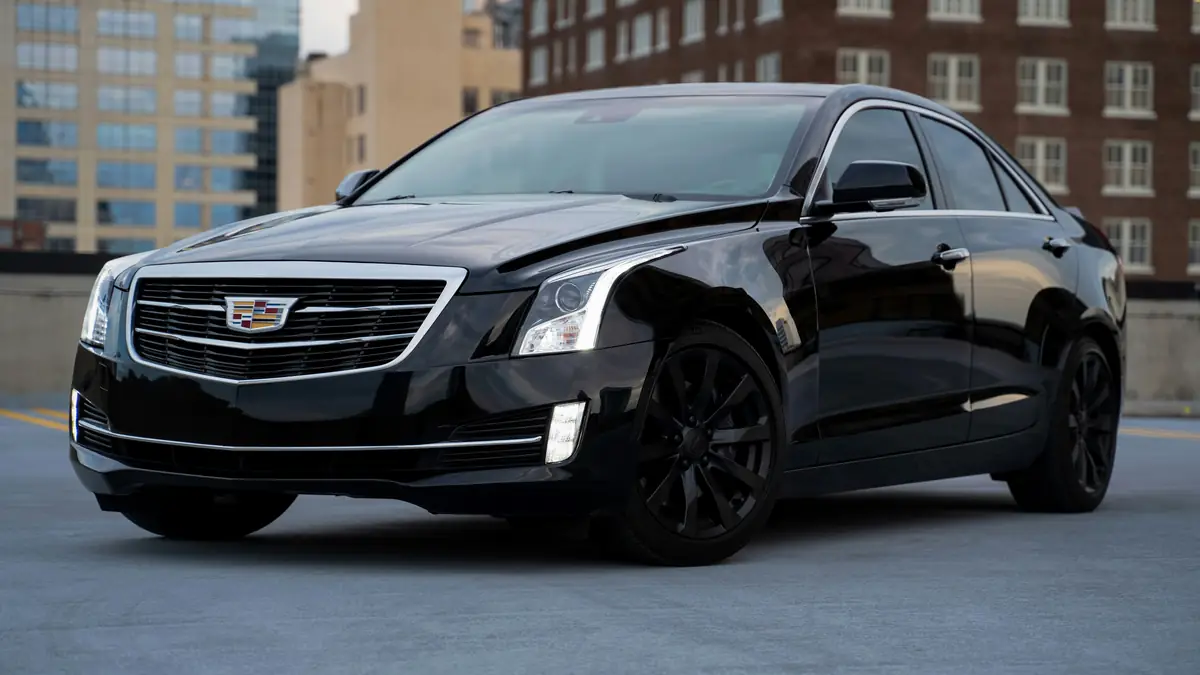 Black executive sedan parked in a city setting
