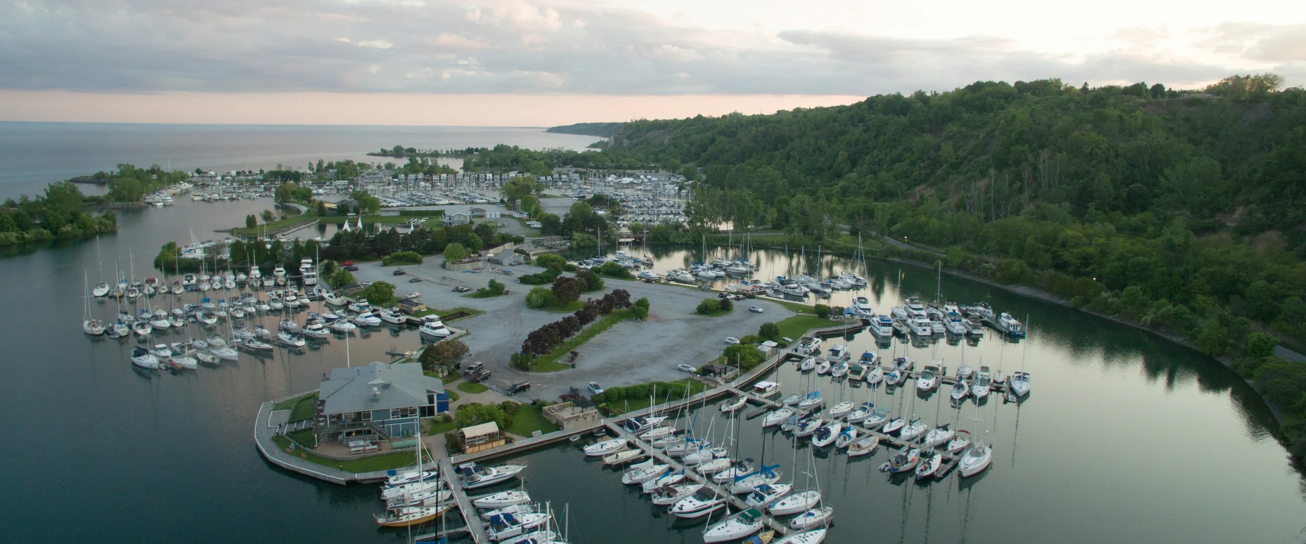 Marina and wooded Scarborough Bluffs along Lake Ontario at dusk