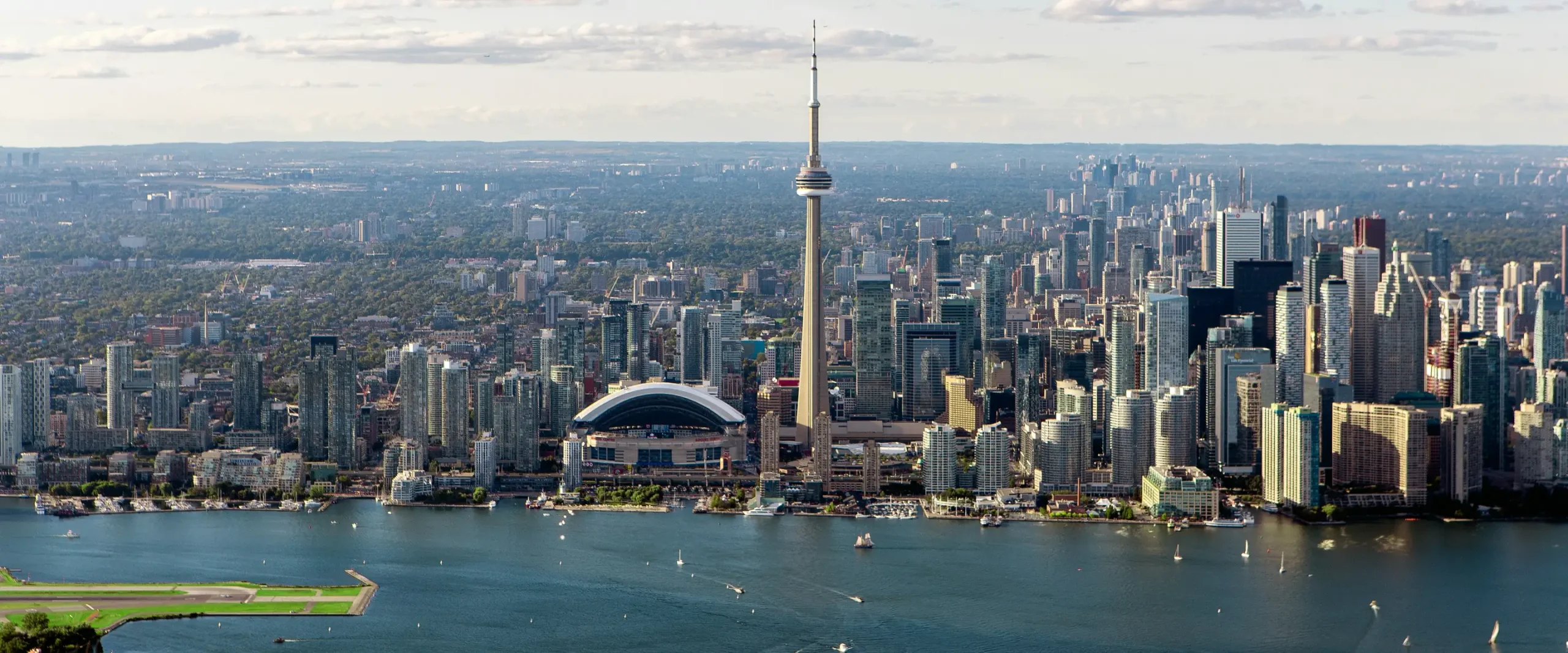 Aerial view of the Toronto skyline, CN Tower and Billy Bishop airport from the harbour